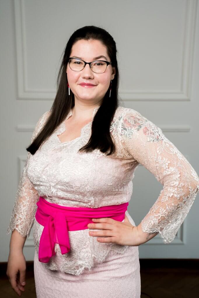 Woman in lace dress with pink sash