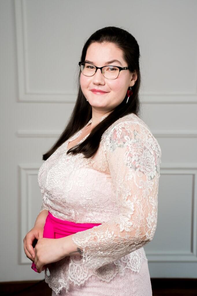 Woman in lace top with pink sash